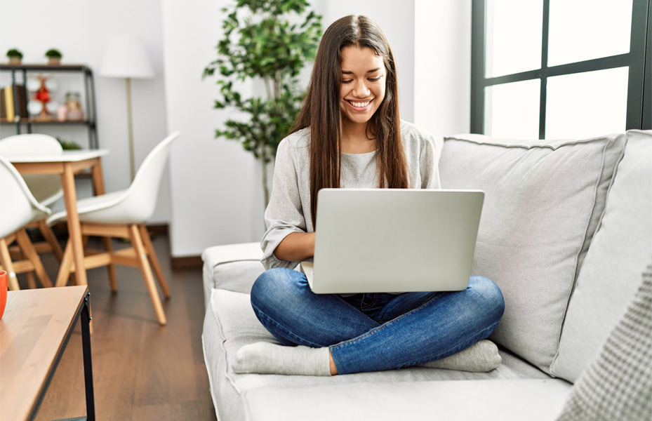Woman on a couch on a laptop