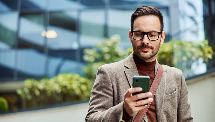 Man holding phone in a suit