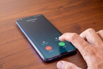 Hand and phone with Unkown caller