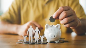 Piggy bank with family paper cut outs