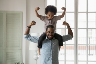 father with son on his shoulders